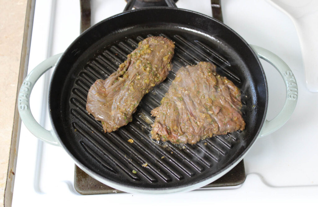 Ranchera meat on a grill pan on the stove. 