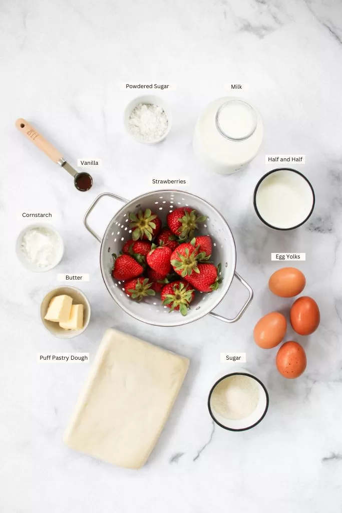 Strawberry croissant ingredients including strawberries, eggs, puff pastry dough, butter, sugar, cornstarch, half and half, milk, vanilla, and powdered sugar. 