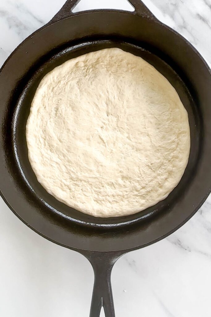pizza dough in a cast iron skillet.