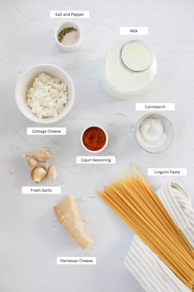 Cajun alfredo sauce ingredients on a stone countertop 